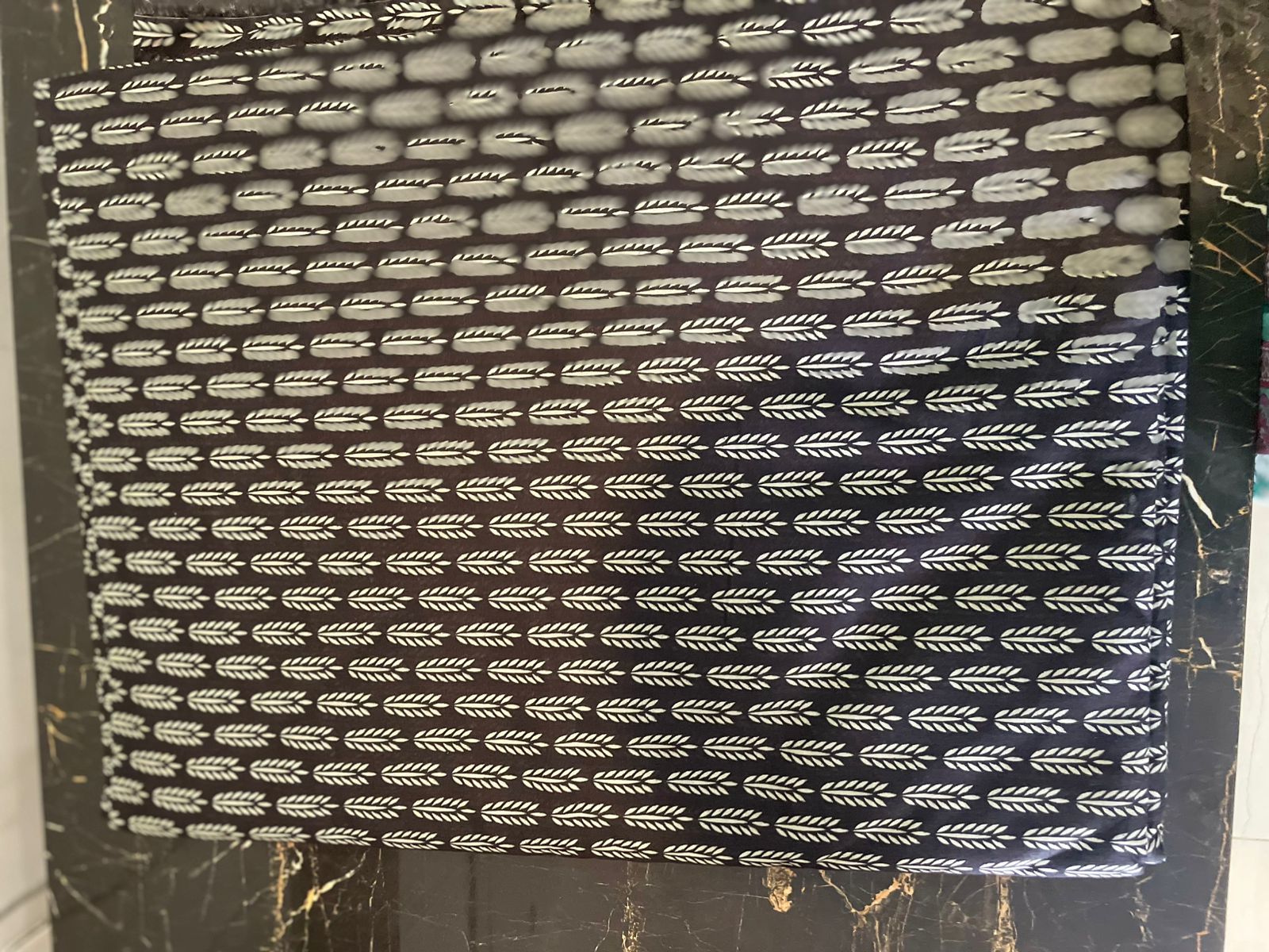Textile with a pattern of small arrows 
