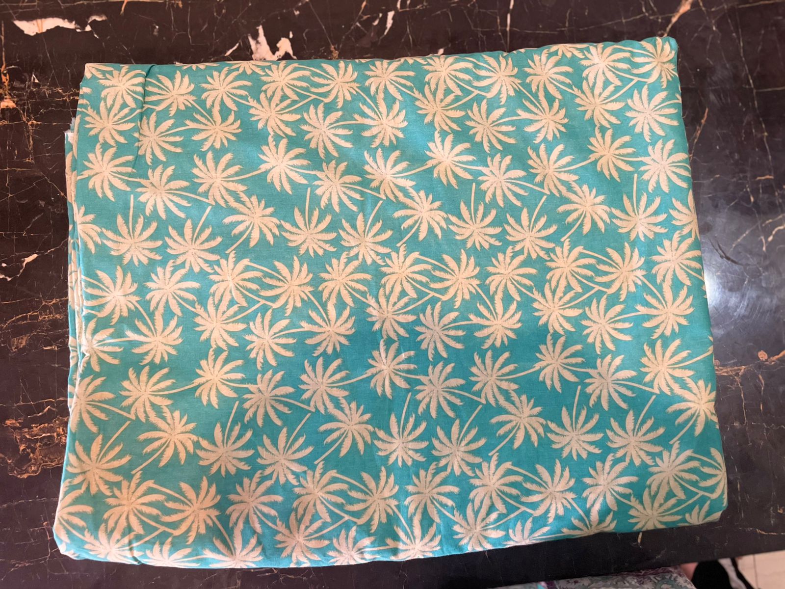 Teal fabric with white floral pattern